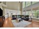 Bright living room featuring a soaring ceiling, large windows, and an open floor plan at 3870 Cabalzar St, Cumming, GA 30040
