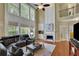 Spacious living room with a fireplace, large windows, and an open view to the upper level at 3870 Cabalzar St, Cumming, GA 30040