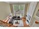 Aerial view of the living room with a fireplace, dining table, and large windows at 3870 Cabalzar St, Cumming, GA 30040