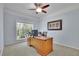Bright office space with a large window, ceiling fan, and built-in desk at 3870 Cabalzar St, Cumming, GA 30040