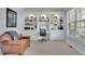 Well-lit office featuring built-in shelving, a desk, and a comfortable chair at 3870 Cabalzar St, Cumming, GA 30040