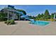 Community pool waterslide feature with tiled pool edge, concrete deck, and shade umbrella at 3870 Cabalzar St, Cumming, GA 30040