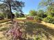 Landscaped and fenced back yard featuring mature trees, grass, and shade at 563 Hillandale Circle Sw, Marietta, GA 30064