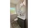 Stylish half bathroom with a modern vanity, decorative mirror, and patterned tile floor at 563 Hillandale Circle Sw, Marietta, GA 30064