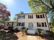 Charming two-story home with a brick facade, black shutters, and landscaped front yard at 563 Hillandale Circle Sw, Marietta, GA 30064