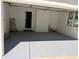 Spacious and bright garage space with gray epoxy floor and white brick detail at 563 Hillandale Circle Sw, Marietta, GA 30064