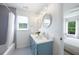 Bathroom featuring double vanity with modern fixtures and a shower-tub combo at 648 Gold Valley Pass, Canton, GA 30114