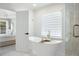 Tranquil bathroom featuring a soaking tub, shower, and view into the primary bedroom at 648 Gold Valley Pass, Canton, GA 30114