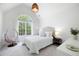 Airy bedroom with a large window, a cozy hanging chair, and neutral décor at 648 Gold Valley Pass, Canton, GA 30114