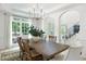 Bright dining room features a large table, chandelier and large windows overlooking the front yard at 648 Gold Valley Pass, Canton, GA 30114