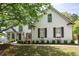 Beautiful white brick home with lush landscaping, arched windows, and a welcoming front entrance at 648 Gold Valley Pass, Canton, GA 30114