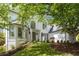 Stately white brick home with well-manicured lawn, beautiful landscaping, and classic architectural details at 648 Gold Valley Pass, Canton, GA 30114