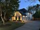 A beautiful home featuring a three-car garage and professional landscape lighting at 648 Gold Valley Pass, Canton, GA 30114