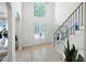 Elegant foyer with a tall ceiling, view through to the front door, and a staircase at 648 Gold Valley Pass, Canton, GA 30114