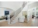 Bright foyer with a modern staircase and views into the living room, featuring light hardwood floors and tasteful decor at 648 Gold Valley Pass, Canton, GA 30114