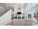Spacious living room with a stone fireplace, high ceilings, and large windows providing natural light at 648 Gold Valley Pass, Canton, GA 30114