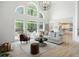 Open concept living room with high ceilings, large arched windows, and backyard deck access at 648 Gold Valley Pass, Canton, GA 30114