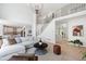 Spacious living room with a staircase, hardwood floors, and an open layout connecting to the kitchen at 648 Gold Valley Pass, Canton, GA 30114