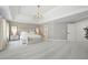 Serene primary bedroom featuring a trey ceiling, neutral tones, and a comfortable sitting area at 648 Gold Valley Pass, Canton, GA 30114