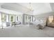 Expansive primary bedroom with tray ceiling, sitting area, and abundant natural light from multiple windows at 648 Gold Valley Pass, Canton, GA 30114