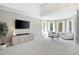 Bright and airy sitting area with large windows, comfortable chairs, and a stylish media console at 648 Gold Valley Pass, Canton, GA 30114