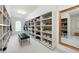 Spacious walk-in closet featuring custom shelving and a large mirror for wardrobe selection at 648 Gold Valley Pass, Canton, GA 30114