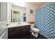 Full bathroom with a sink, toilet, and shower with a patterned curtain, complemented by modern fixtures at 7779 Haynes Park Cir, Lithonia, GA 30038