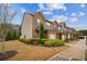 Angle view of townhomes with brick and beige siding, along with landscaping at 7779 Haynes Park Cir, Lithonia, GA 30038