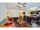Open-concept living room and kitchen with dark wood floors and stainless steel appliances at 7779 Haynes Park Cir, Lithonia, GA 30038