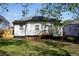 Exterior of a home featuring a small deck, gray siding, and a well-maintained yard at 1515 Jonesboro Rd, Atlanta, GA 30315