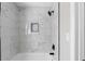 Bathroom shower featuring marble tiling and black fixtures at 1515 Jonesboro Rd, Atlanta, GA 30315