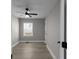 Empty bedroom with a large window, light gray walls, and hardwood floors at 1515 Jonesboro Rd, Atlanta, GA 30315