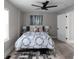 Comfortable bedroom featuring light gray walls, wood floors, a ceiling fan, and a large window at 1515 Jonesboro Rd, Atlanta, GA 30315