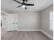 Bedroom with light gray walls, wood-look flooring, ceiling fan and white door at 1515 Jonesboro Rd, Atlanta, GA 30315