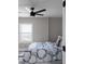 Bedroom with a window, bed with patterned comforter, and a ceiling fan at 1515 Jonesboro Rd, Atlanta, GA 30315