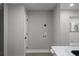 Hallway adjacent to the kitchen with a utility closet hookup, white door and gray walls at 1515 Jonesboro Rd, Atlanta, GA 30315