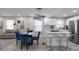 Open kitchen and living area with an island, bar stools, and adjacent dining area at 1515 Jonesboro Rd, Atlanta, GA 30315