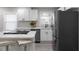 Close up of the kitchen area with a modern refrigerator, white cabinets, and a kitchen island at 1515 Jonesboro Rd, Atlanta, GA 30315