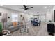 Open-concept living room and kitchen area with a ceiling fan, modern lighting, and wood flooring at 1515 Jonesboro Rd, Atlanta, GA 30315