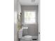 Small powder room featuring a window, mirror, sink, and toilet at 1515 Jonesboro Rd, Atlanta, GA 30315