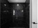 Shower space with black marble tiling, sleek fixtures, and modern design elements at 1515 Jonesboro Rd, Atlanta, GA 30315