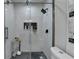 Updated bathroom features glass shower and herringbone tile at 226 Sandra Nw Dr, Lilburn, GA 30047