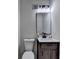 Small powder room with a modern vanity, black faucet, and a convenient corner sink at 226 Sandra Nw Dr, Lilburn, GA 30047