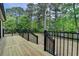 New wooden deck overlooks a lush backyard with mature trees and water view at 226 Sandra Nw Dr, Lilburn, GA 30047