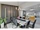 Elegant dining room featuring modern black accent wall, contemporary chandelier and seating for six at 226 Sandra Nw Dr, Lilburn, GA 30047