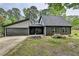 Charming home featuring a two-car garage and complemented by landscaping, offering both convenience and curb appeal at 226 Sandra Nw Dr, Lilburn, GA 30047