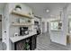 Bright kitchen featuring white cabinets, stainless steel appliances, wood-look floors, and decorative shelving at 226 Sandra Nw Dr, Lilburn, GA 30047