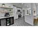 Modern kitchen with white cabinets, stainless steel appliances, island seating, and decorative floating shelves at 226 Sandra Nw Dr, Lilburn, GA 30047