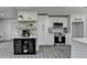 Well-lit kitchen featuring white cabinets, stainless steel appliances, floating shelves, and a functional island at 226 Sandra Nw Dr, Lilburn, GA 30047