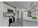 Updated kitchen featuring white cabinets, stainless appliances, sleek countertops, and access to an outdoor patio at 226 Sandra Nw Dr, Lilburn, GA 30047